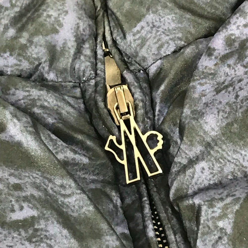 MONCLER EBONY GIUBBOTTO EBONY JACKET, featuring a metal logo and all-over print. This long-sleeved polyester down jacket is perfect for women and features a navy blue interior.