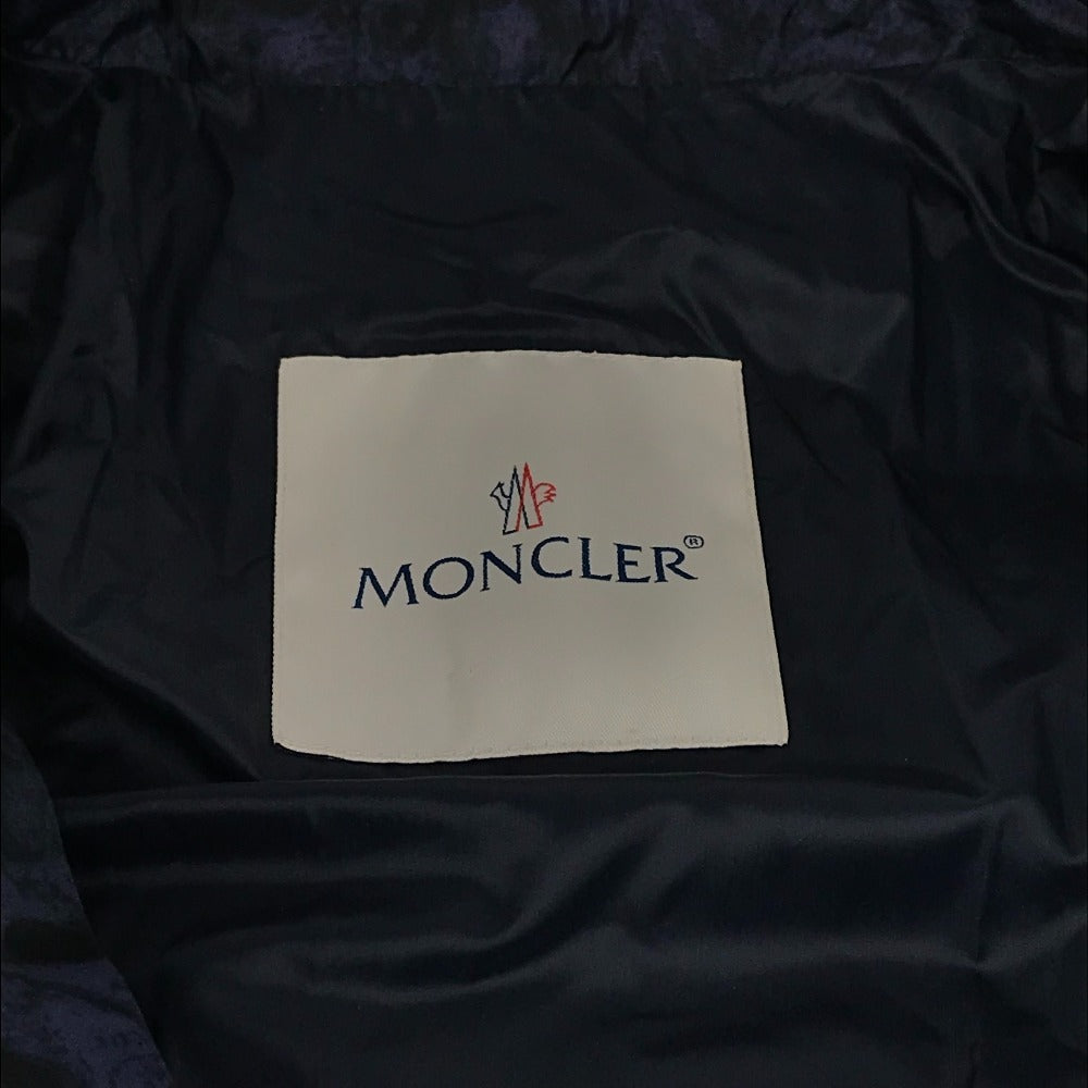 MONCLER EBONY GIUBBOTTO EBONY JACKET, featuring a metal logo and all-over print. This long-sleeved polyester down jacket is perfect for women and features a navy blue interior.