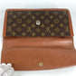 LOUIS VUITTON M51810 Monogram Pochette Dame GM. This unisex Monogram canvas Pochette Dame GM clutch bag is perfect as a pouch or second bag. It's brown and unisex.