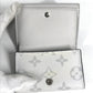 LOUIS VUITTON M67621 Taiga Rama Discovery Compact Wallet, a tri-fold wallet in Taiga leather, unisex, in blanc and white.